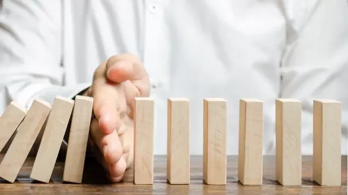 hand stopping blocks from tipping over