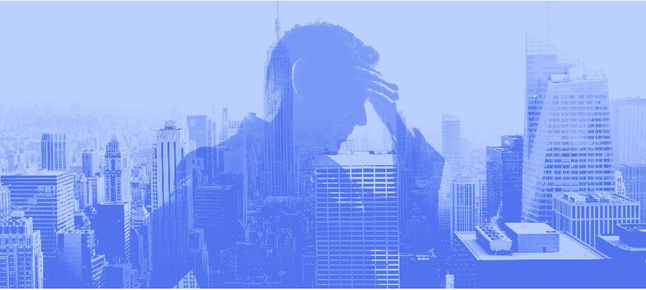 man stressed in front of a city skyline