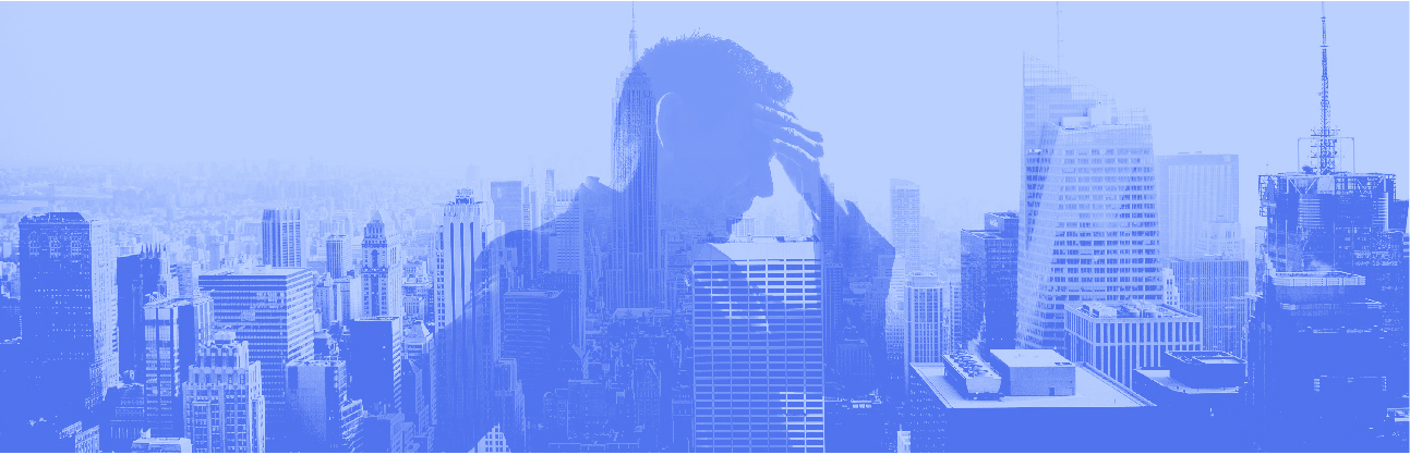 man stressed in front of a city skyline