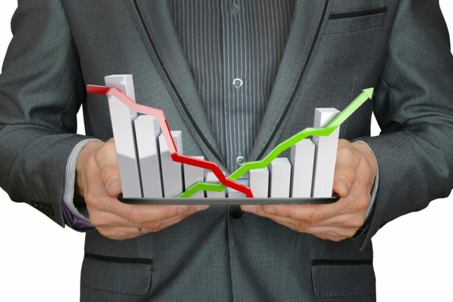 man holding a falling and rising stock chart