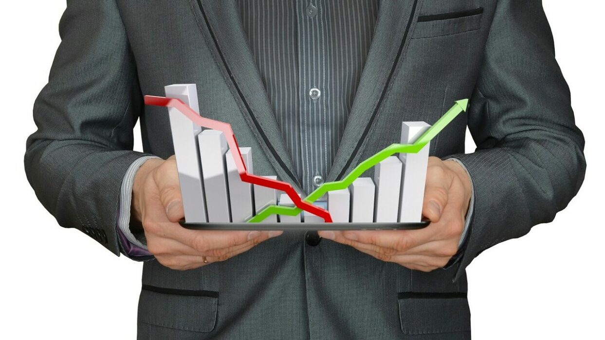 man holding a falling and rising stock chart