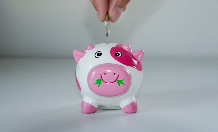 putting a coin in a piggy bank
